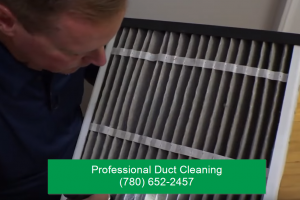 professional duct cleaning guy inspecting vent in edmonton